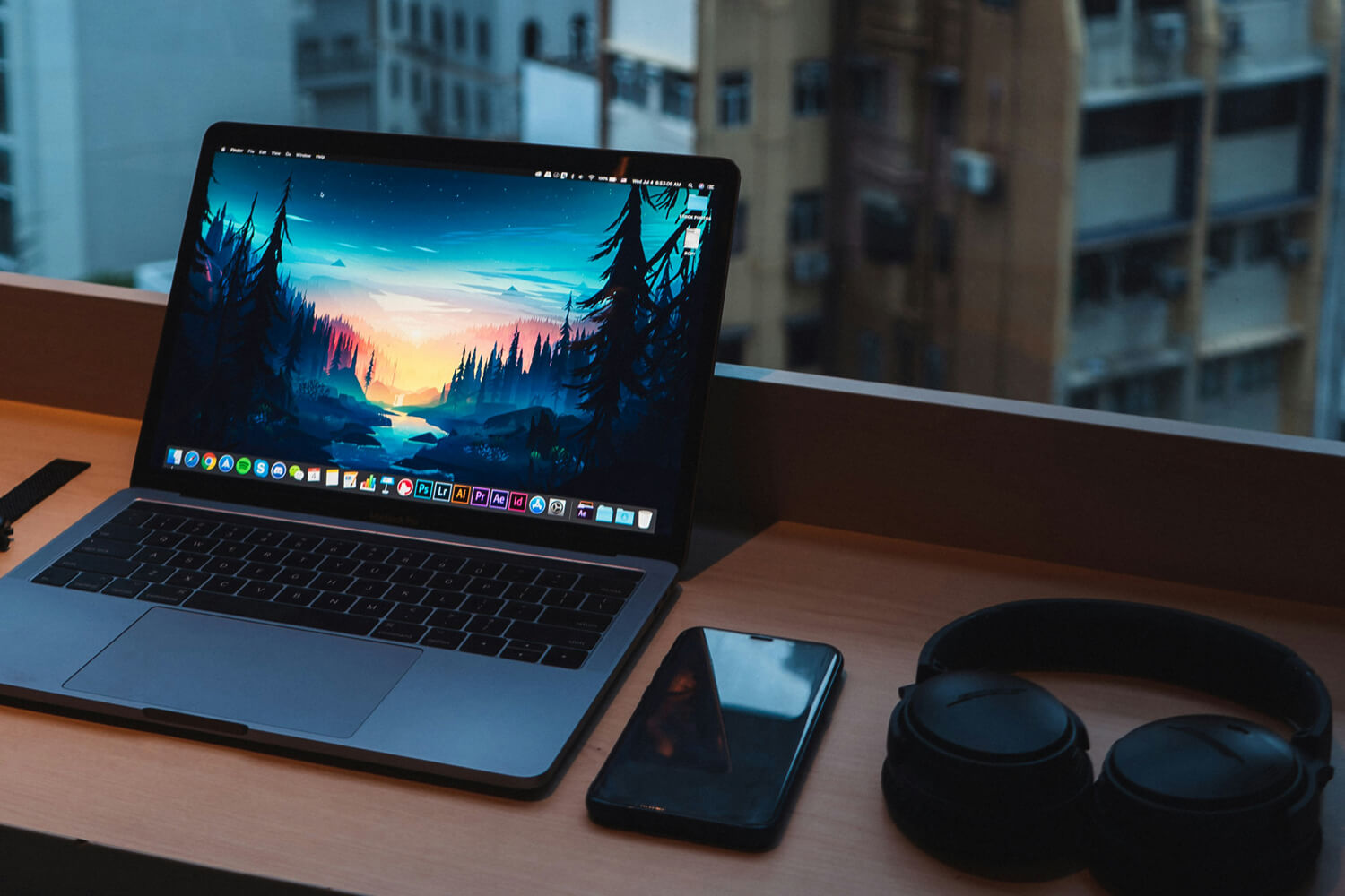 An image of a laptop and auxiliary devices next to it for content strategizing